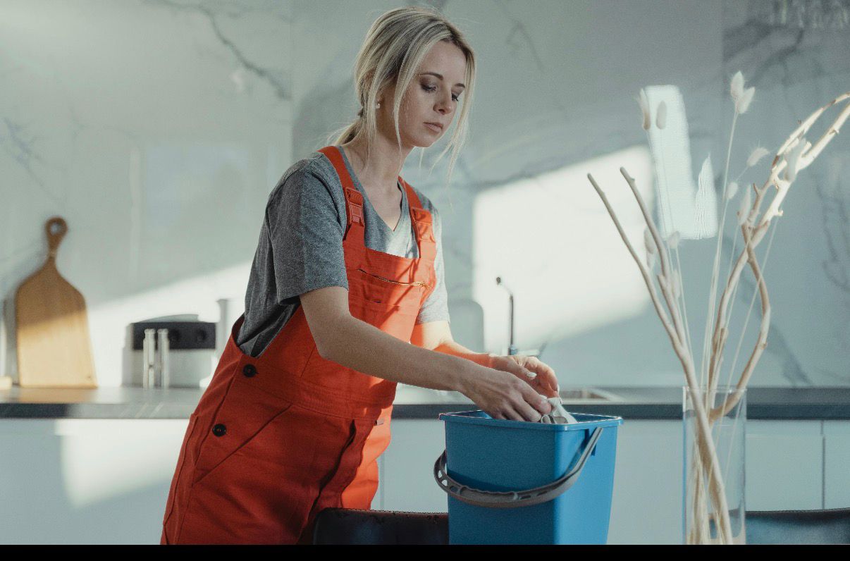 Cleaner preparing equipment in a luxury kitchen